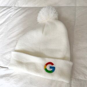 Winter White Pom-Pom Beanie with Multicolor Logo. Pristine condition never worn.